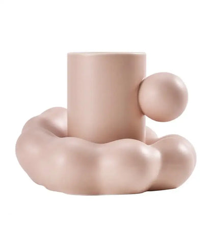 Pastel pink ceramic cup with rounded spherical handle and cloud base in modern cream ceramic cup and saucer set decorbites cotton candy