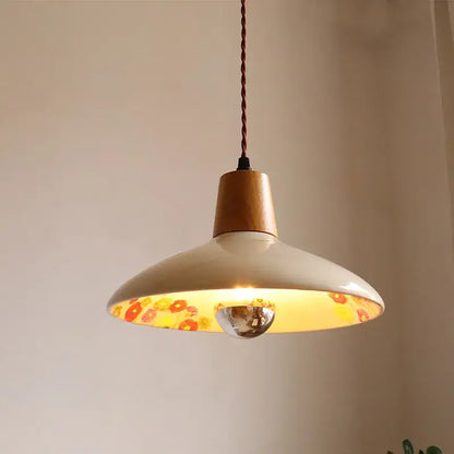 Modern cream ceramic led pendant light with wooden top floral interior and twisted brown cord by decorbites ceramic led pendant