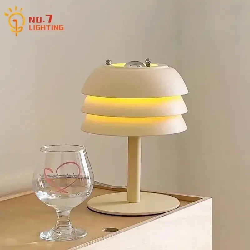Modern cream medieval design table lamp with layered cream shade warm yellow glow and metallic accents for bedroom decorbites cream medieval