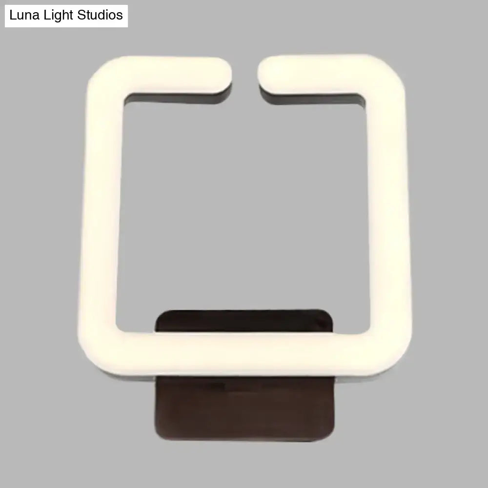 Modern cream square wall sconce with warm white direct wired electric light and dark brown base for natural light ambiance