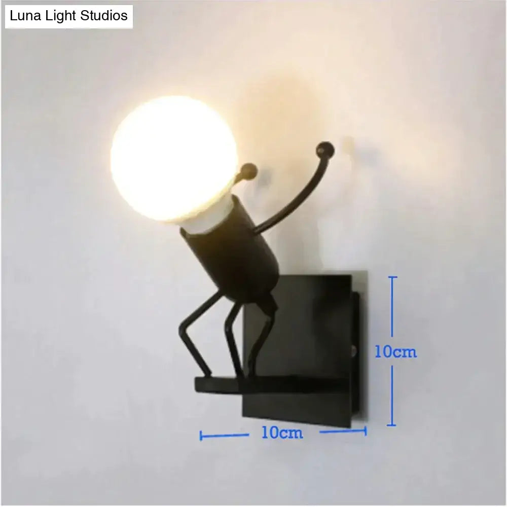 Black metal wall sconce in creative minimalism metal robot design holding an illuminated bulb for modern bedroom light