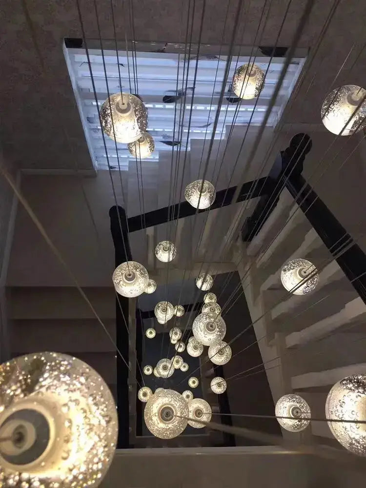 Modern crystal ball led chandelier featuring textured glass orbs suspended by cables for living room decorbites decor