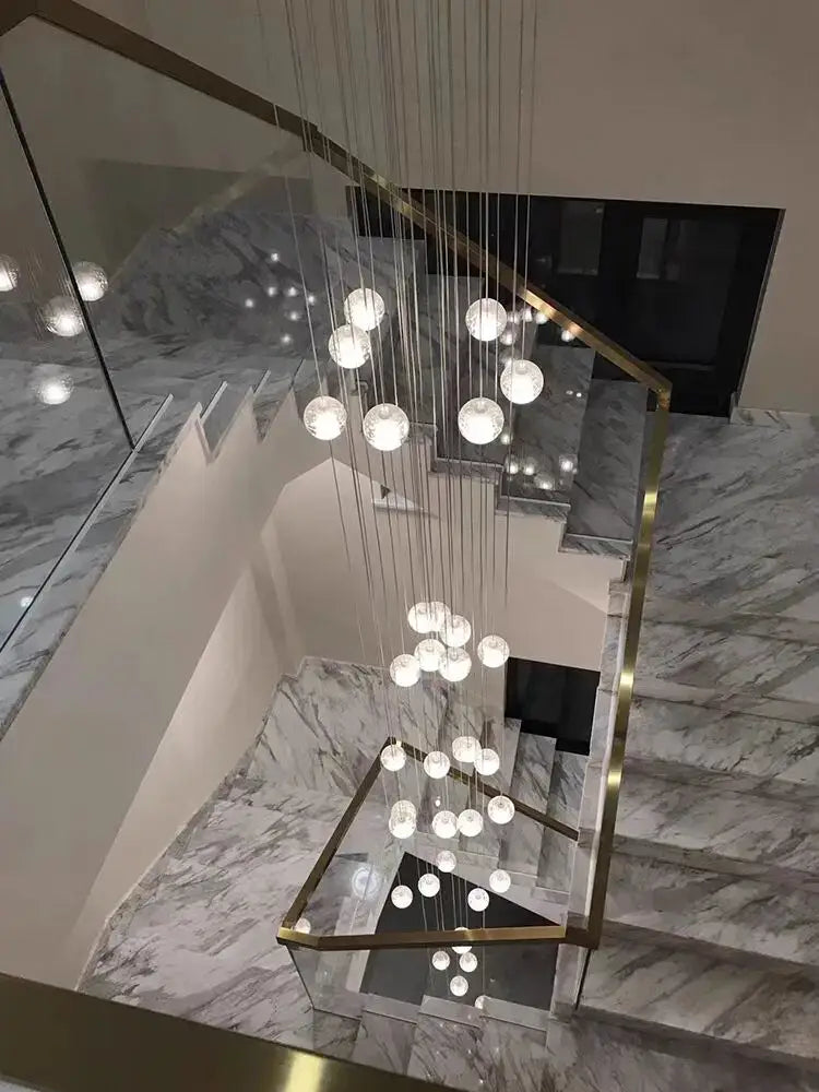 Modern crystal ball led chandelier with spherical glass and cascading design suspended by metallic wires for living room decorbites decor