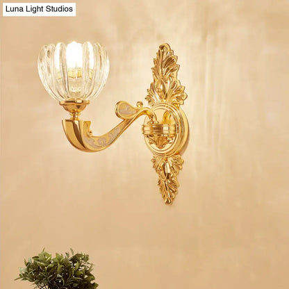 Modern crystal block gold wall lamp fixture with gold-toned ornate design and faceted crystal glass shade bedroom sconce