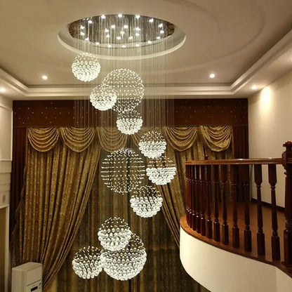 A modern clear crystal chandelier with cascading spherical clusters from decorbites crystal chandelier collection
