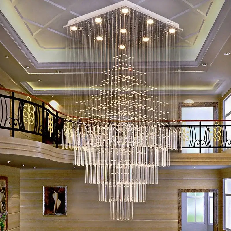 A modern decorbites crystal column chandelier with cascading clear glass rods hanging from a white ceiling fixture