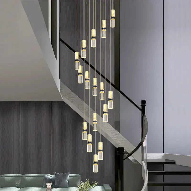 Modern crystal columnar chandelier with clear glass cylinders and gold-toned metallic accents for stairwell lighting