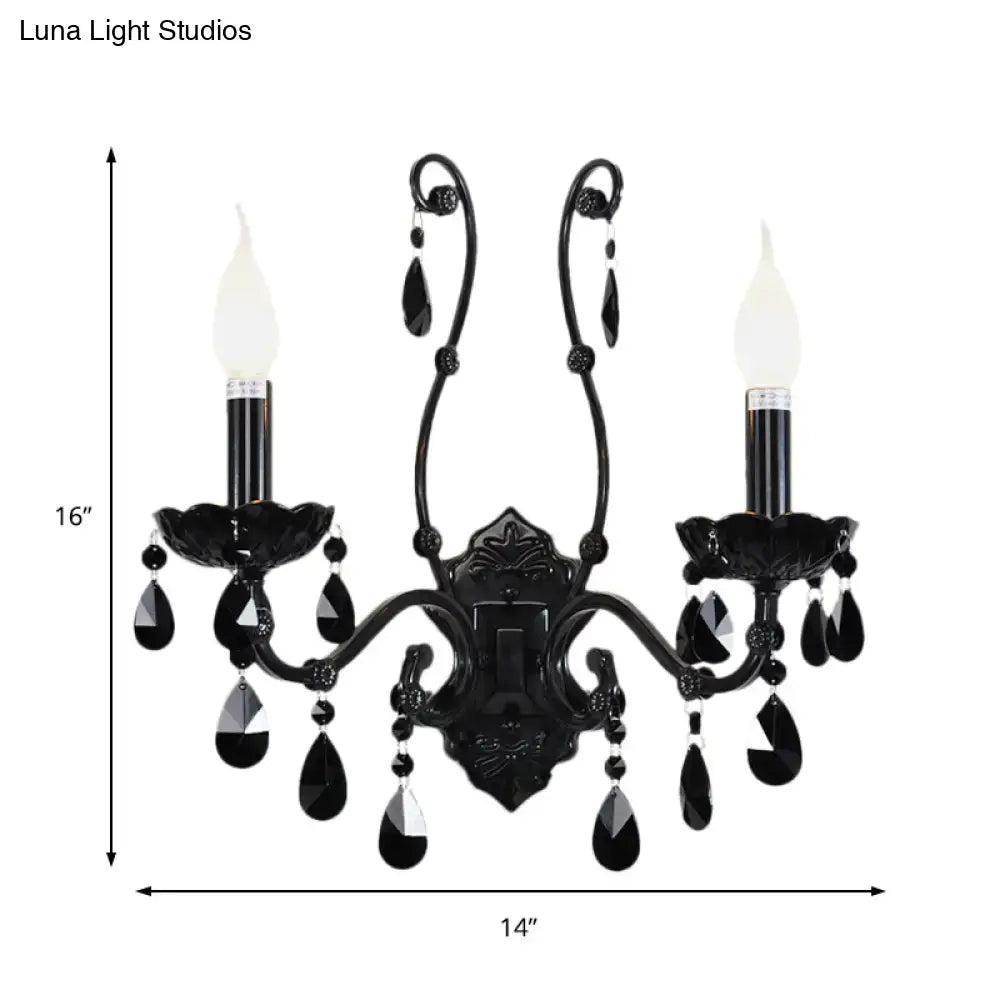 Black ornate modern crystal cone wall mount sconce with teardrop accents and two candle-style bulbs for living room