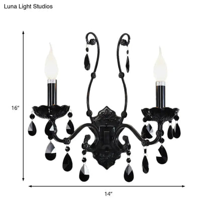 Black ornate modern crystal cone wall mount sconce with teardrop accents and two candle-style bulbs for living room