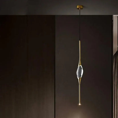 A modern crystal copper wall sconce with a gold-toned metal frame and clear faceted crystal centerpiece for dining room decorbites