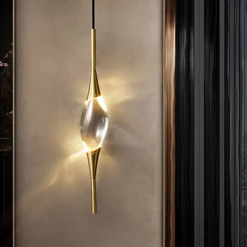 Modern crystal copper wall sconce with gold-toned metal frame and clear crystal element for warm dining room decorbites light