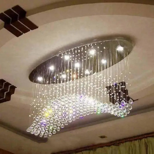 Modern crystal flush mount oval chandelier with cascading crystal beads and sleek metallic frame for living room decorbites