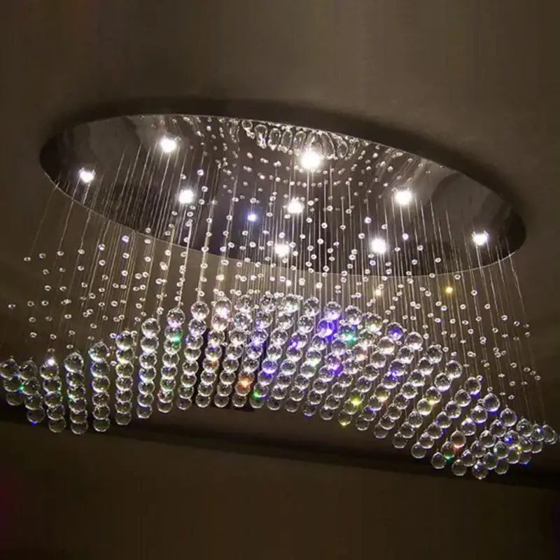 Modern crystal flush mount chandelier with oval metallic frame and cascading clear multicolored glass beads for living room decorbites