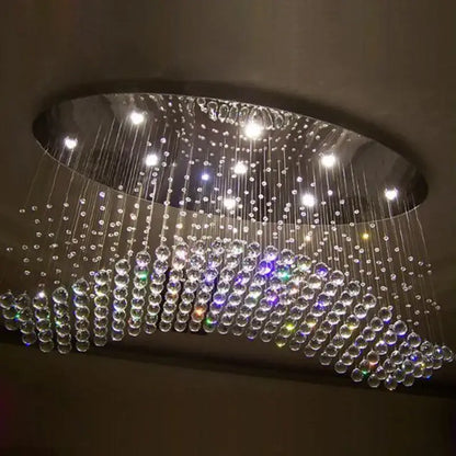 Modern crystal flush mount chandelier with oval metallic frame and cascading clear multicolored glass beads for living room decorbites