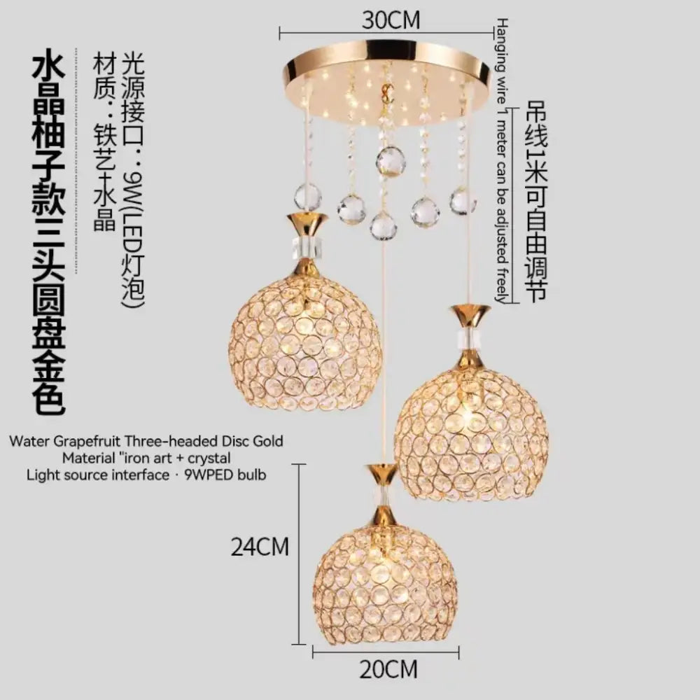 Modern three-headed crystal gold ceiling chandelier with spherical faceted glass orbs and dangling clear crystals for luxury decorbites crystal gold lighting