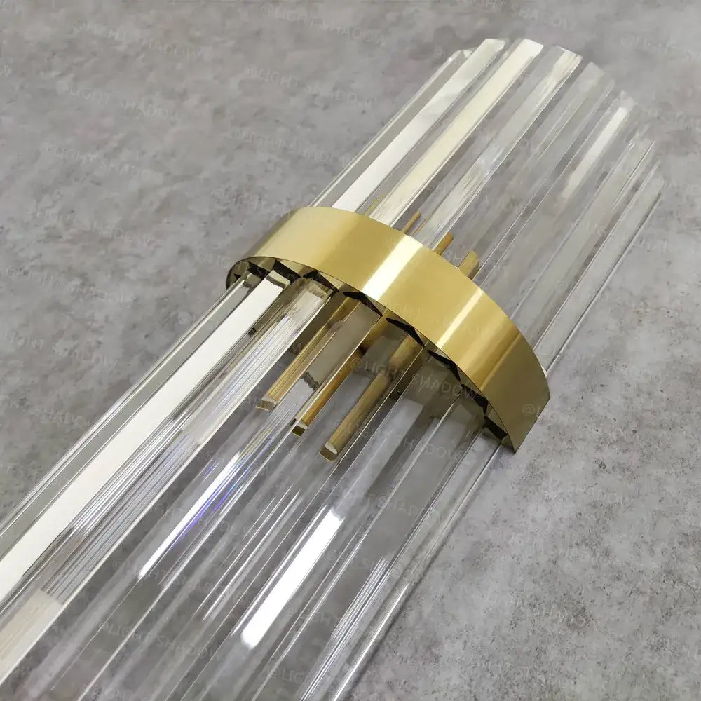 Modern crystal gold led wall lamp with clear glass prism and polished gold-toned metal band for bedroom lighting decorbites crystal gold