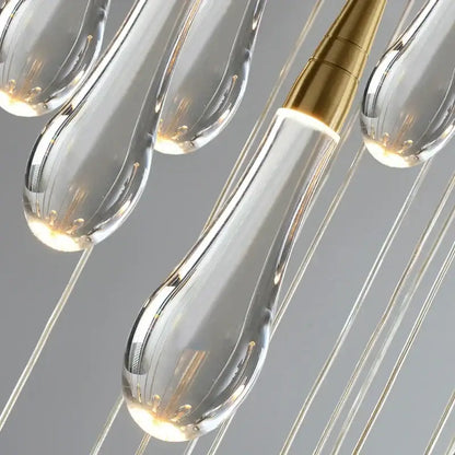 Modern crystal gold pendant lights featuring five clear teardrop-shaped glass pendants with gold-toned fixtures