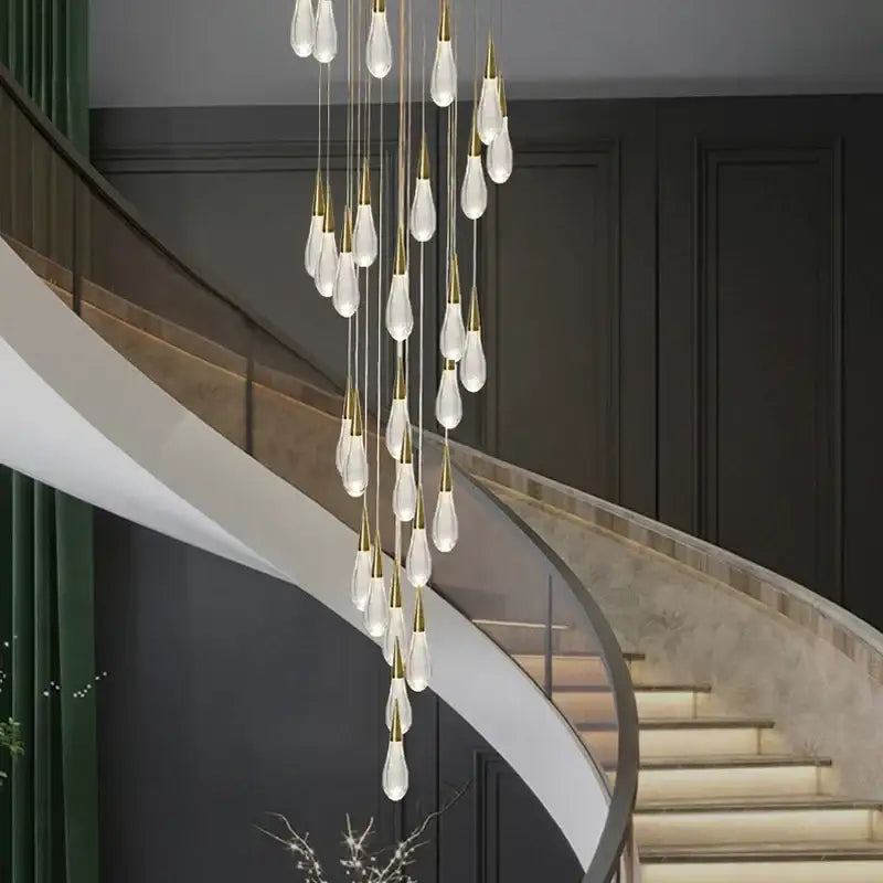 Elegant modern pendant lights featuring clear teardrop glass pendants and gold-toned decorbites crystal gold accents