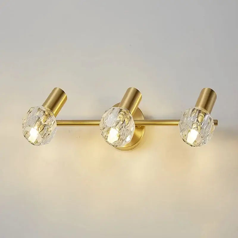 Modern crystal gold wall lamp featuring a gold-toned wall lamp with three crystal globe shades for bedroom decorbites crystal gold
