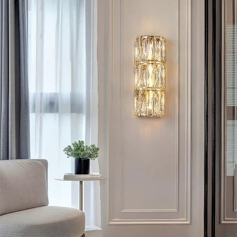 A modern crystal led wall lamp with stacked faceted crystal segments emitting a warm golden glow for living room decorbites crystal led wall
