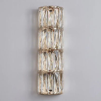 A modern crystal led wall lamp with three stacked tiers of faceted crystals in polished gold-toned metal for living room decorbites crystal led wall