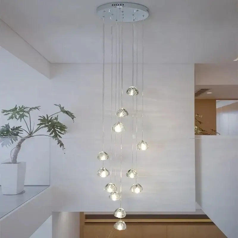 Modern silver-toned crystal water droplet chandelier with multiple spherical lights for staircase pendant lighting