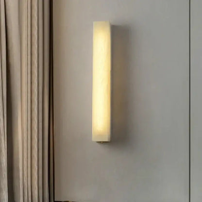 A sleek off-white cuboid marble led wall lamp with warm diffused glow for bedroom dimmable lighting decorbites cuboid marble