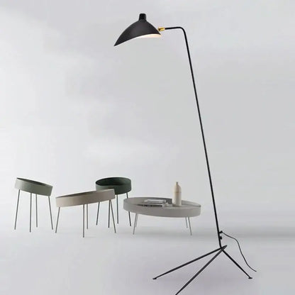 Modern curved black metal floor lamp with a sleek curved arm and conical shade for bedroom reading lighting decorbites black metal floor