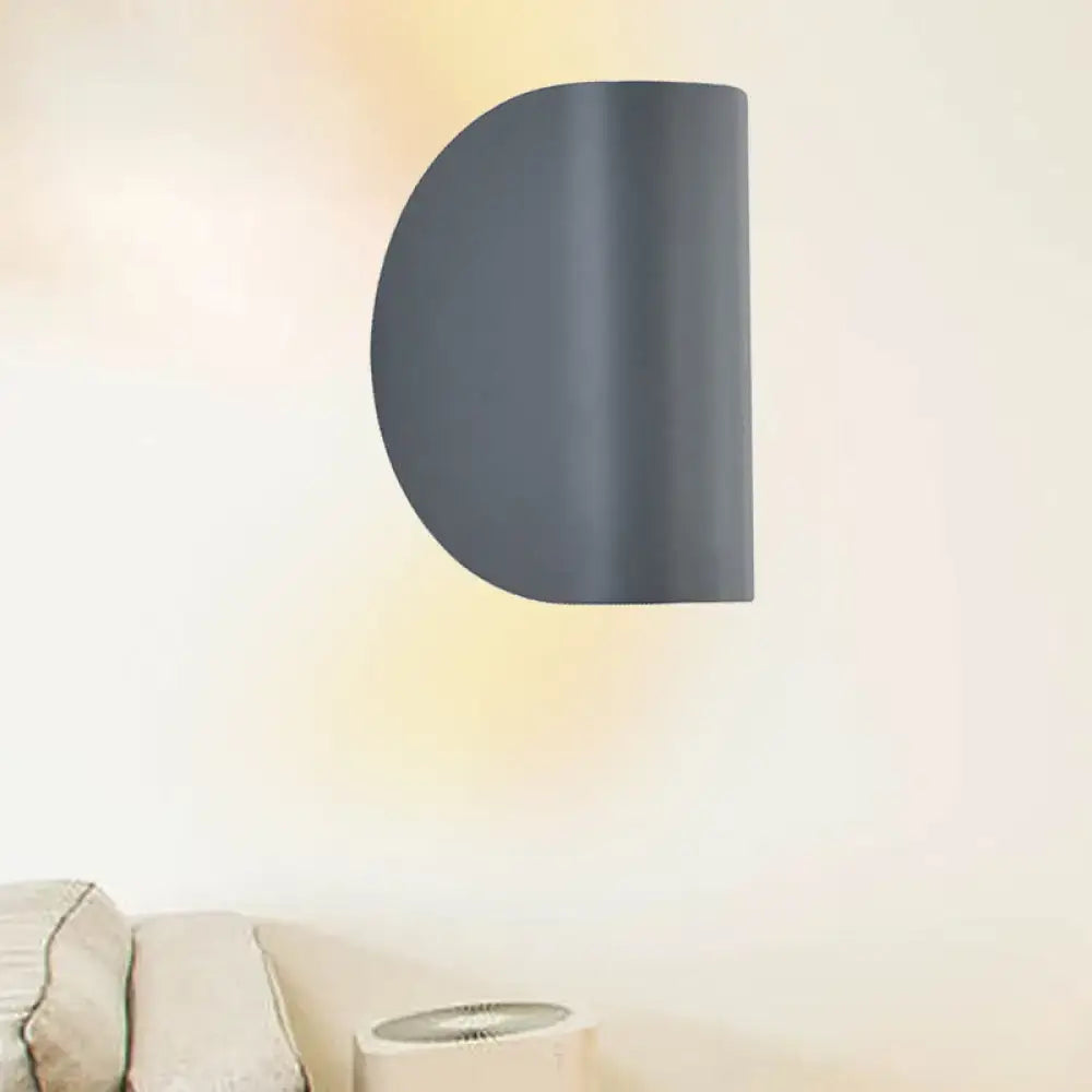 Dark gray semi-circular wall sconce light with a matte finish for modern bedroom ambient lighting in black grey tone