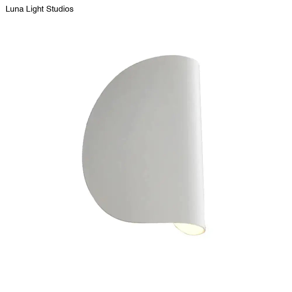 Modern curved gold wall sconce light with smooth curved design and soft diffused bedroom ambient lighting