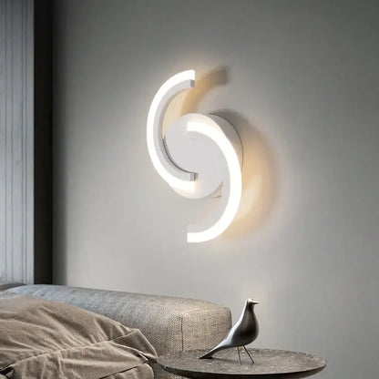 Modern curved white led wall sconces with a sleek swirling design for bedroom lighting by decorbites led wall sconces