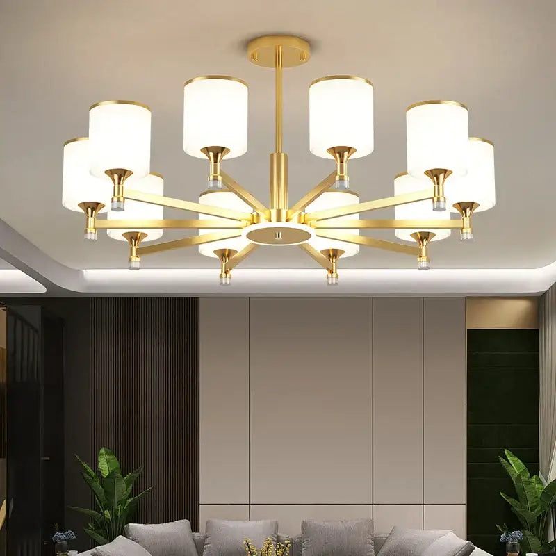 Modern dark bronze decorbites glass chandelier with gold-toned starburst design and white cylindrical glass shades for living room light