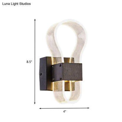Modern dark bronze led wall lamp with sleek black metal base and ribbed glass arms emitting white warm light for bedroom