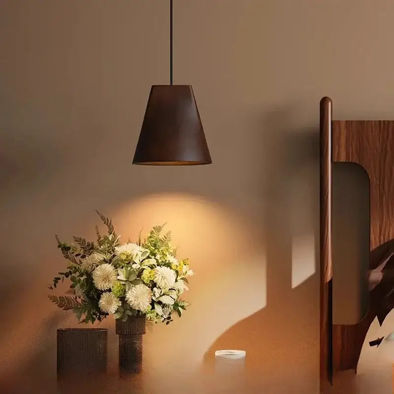 Dark brown conical pendant light with matte finish hanging from black cord in decorbites adjustable wooden chandelier