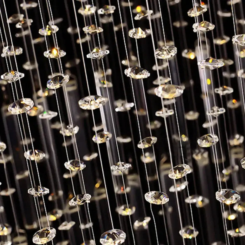 A decorbites crystal columnar chandelier with clear faceted crystal droplets on metallic wires for stair loft lighting