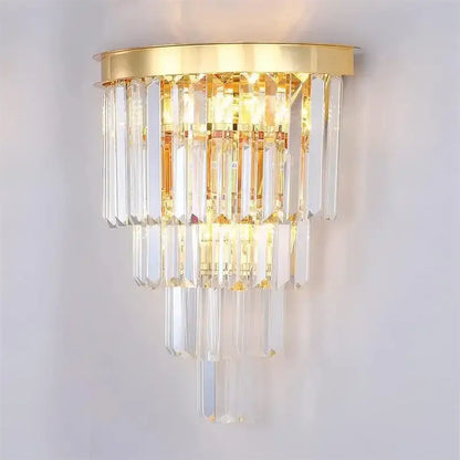 Modern decorbites crystal gold led chandelier featuring a gold-toned wall sconce with cascading clear crystal prisms