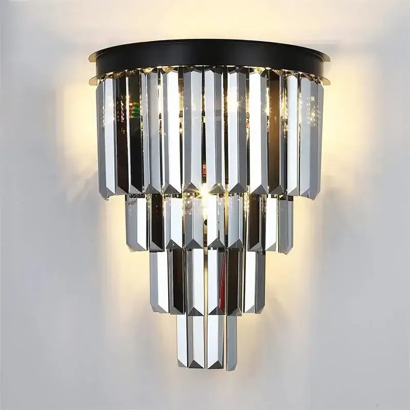 A modern decorbites crystal gold led chandelier with cascading faceted crystal prisms and a gold black circular base