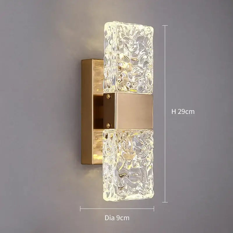 Modern decorbites crystal gold led wall sconce features clear textured glass panels with gold-toned metal base