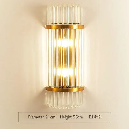 Gold-toned decorbites crystal gold led wall sconce with vertical crystal rods and warm glowing light for bedroom decor