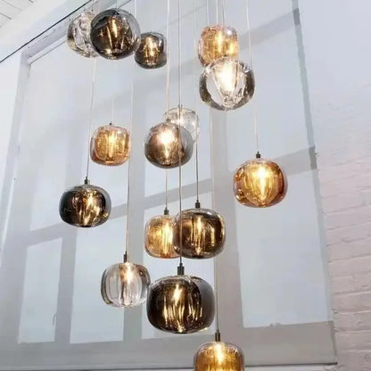 A modern decorbites crystal led chandelier with amber gold and clear glass orb pendant lights for living room decor