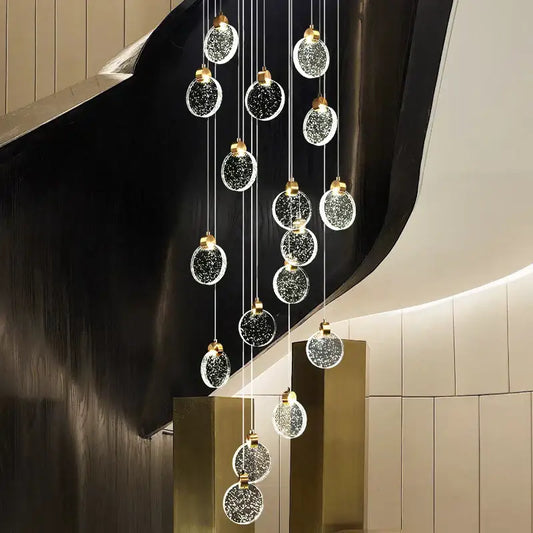 A modern decorbites crystal led chandelier with multiple glass orbs embedded with sparkling particles for living room
