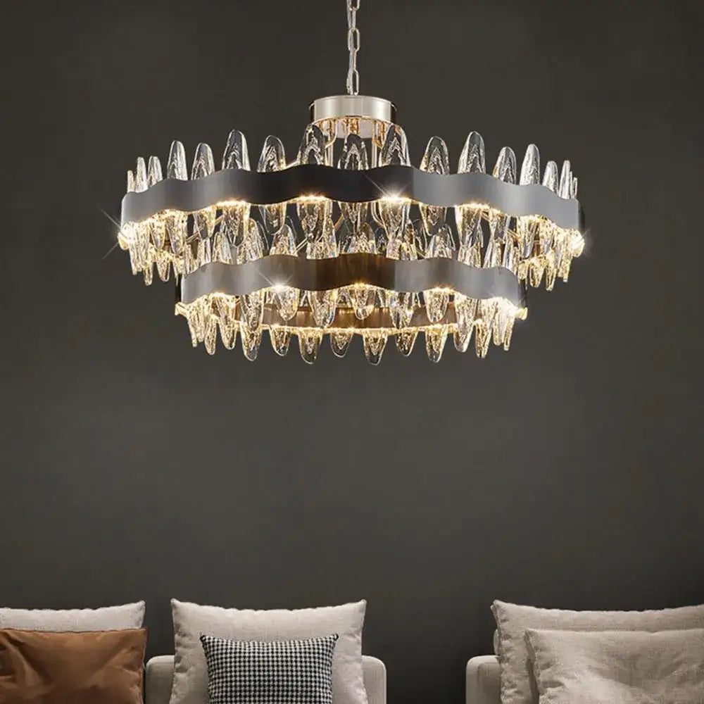 A modern decorbites crystal led chandelier with circular black metal bands and clear crystal droplets for living rooms