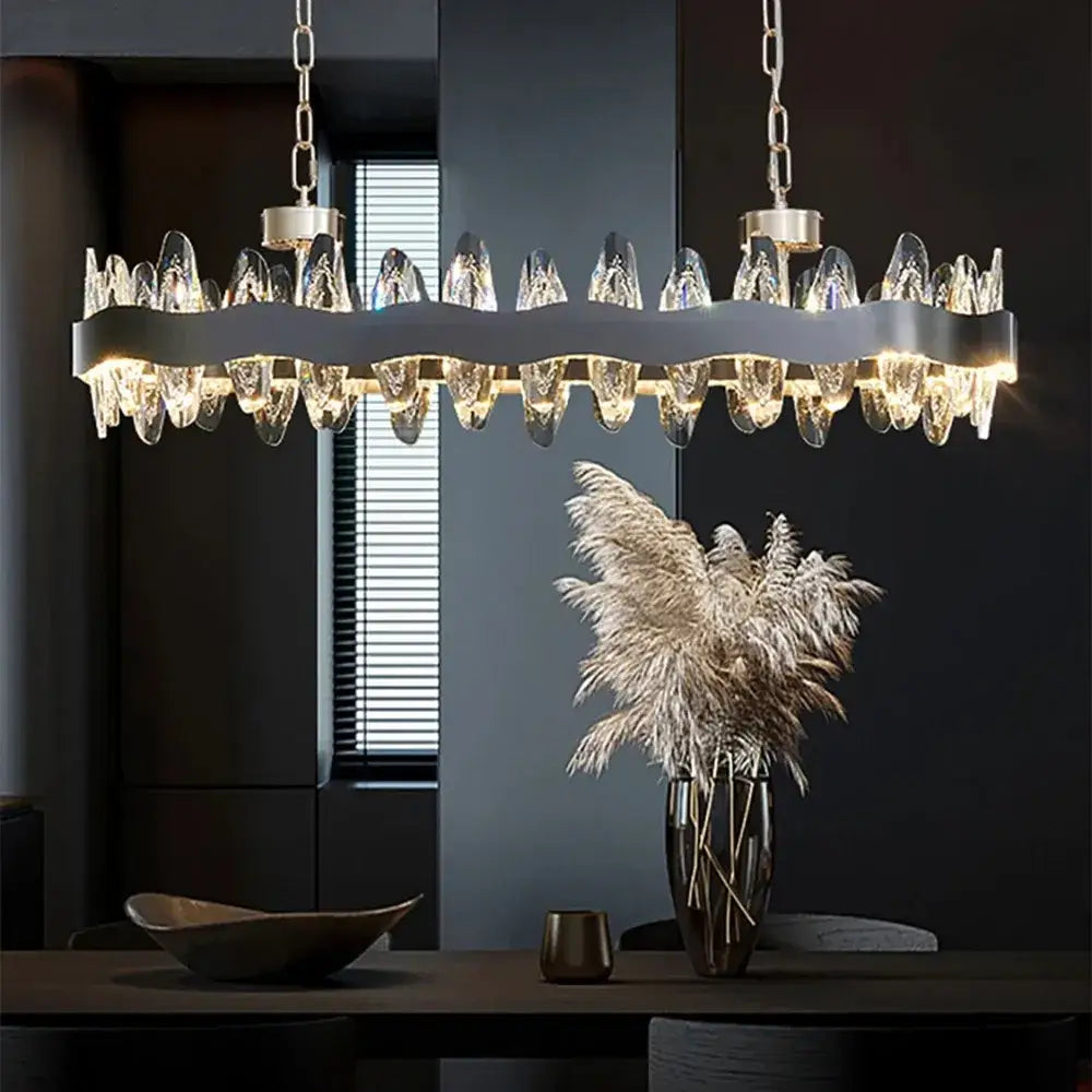 Modern silver-toned decorbites crystal led chandelier with wavy metallic frame and cascading clear crystal droplets for living room