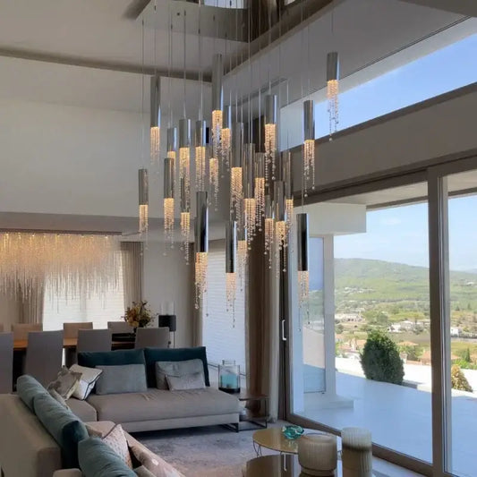 Modern decorbites crystal led chandelier with sleek metallic cylinders and cascading crystal droplets for luxury staircase lighting