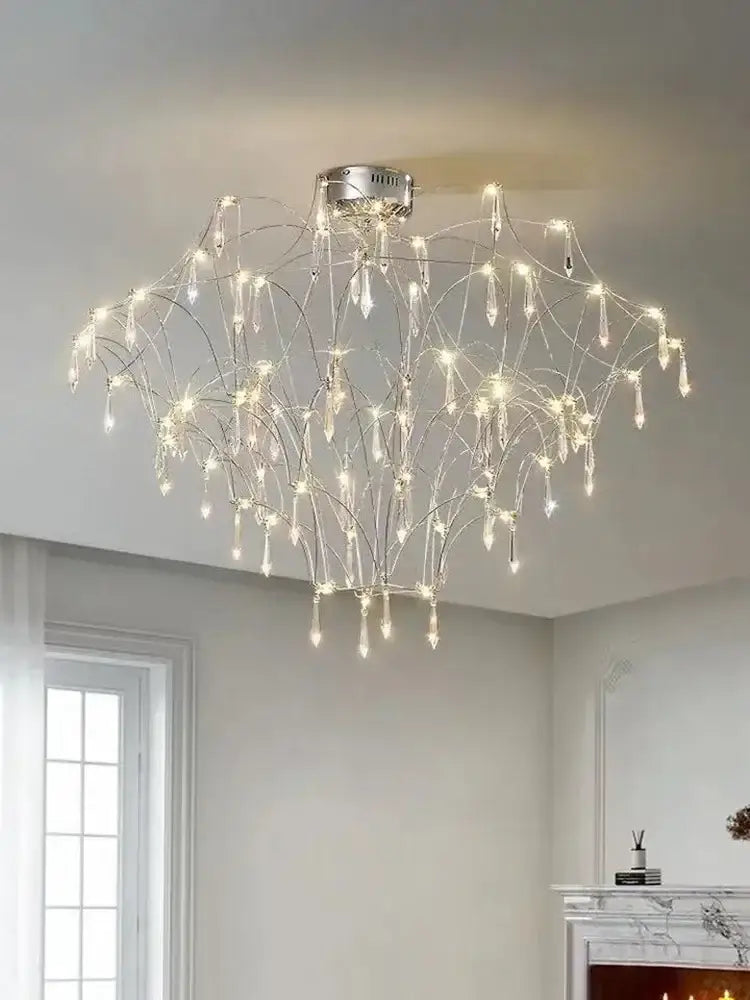 A modern silver-toned decorbites deluxe crystal star lamp with wire arms and crystal droplets emitting warm white light