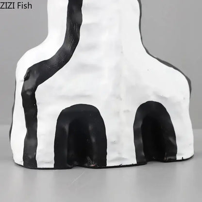 White ceramic decorbites abstract vase with black stripes and archways in modern design for bedroom decor