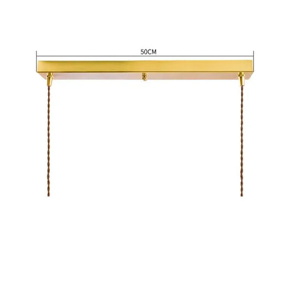 Gold-finished rectangular modern pendant lights with diamond amber glass and twisted brown cords for dining room use