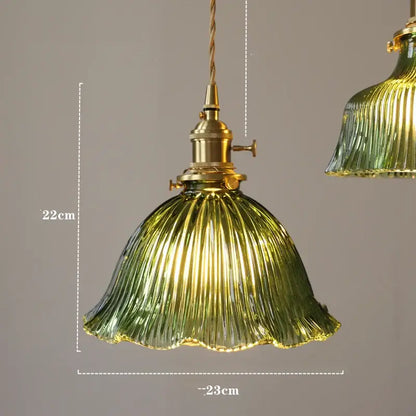 Modern pendant lights featuring a ribbed green diamond amber glass shade with brass hardware for dining rooms