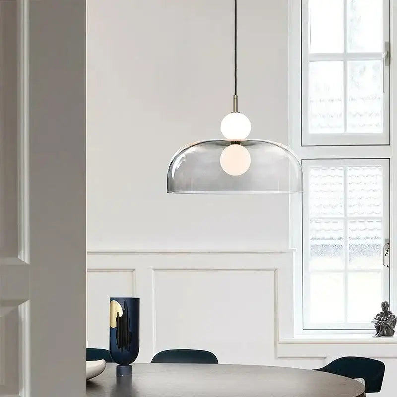 Modern double balls glass pendant light with clear glass dome and two white bulbs suspended by black cord for kitchen use