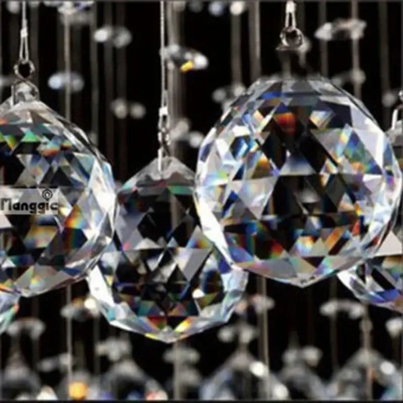 Clear faceted crystal spheres hanging from silver chains in a modern double spiral crystal chandelier for living rooms